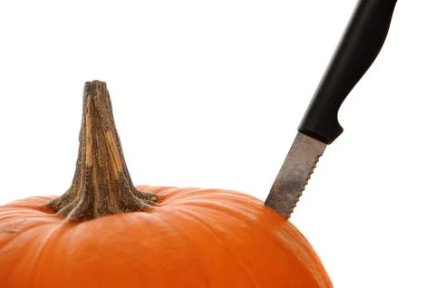 Orange pumpkin  isolated on a white background with a knife stabbed in the si Stock Photos