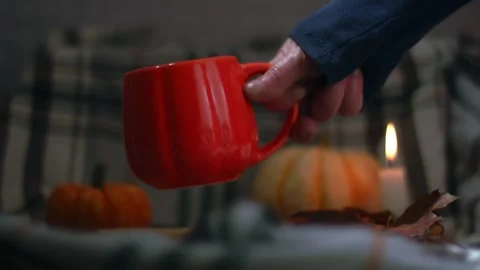 Orange Pumpkin mug of tea on warm candlelight background Stock Footage 321295875