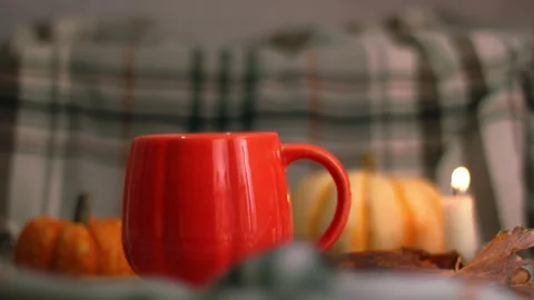 Orange Pumpkin mug of tea on warm candlelight background Vídeos de archivo 323119775