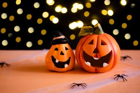 Orange pumpkins on black background and warm light background for greeting card. Stock Photos