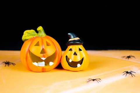 Orange pumpkins on black background. Stock Photos