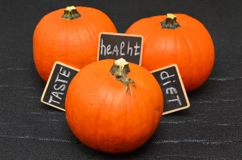 Orange pumpkins on a black background Stock Photos