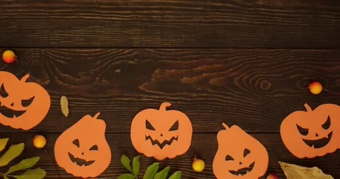 Orange pumpkins shapes, fall leaves and "Happy Halloween" text Stock Footage 345632273