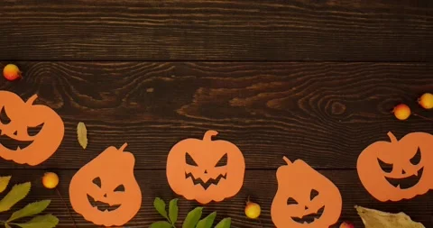 Orange pumpkins shapes, fall leaves and place for text on an wooden background Stock Footage 345632281