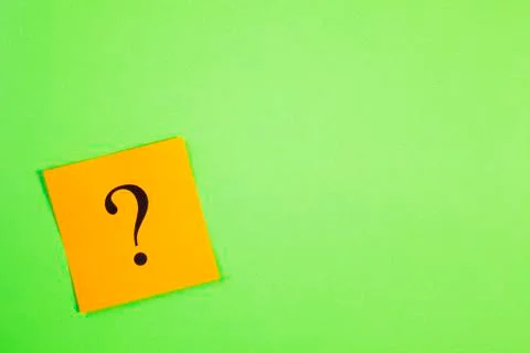 Orange question mark on green background Stock Photos
