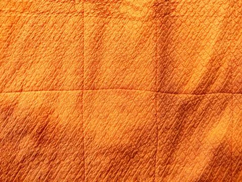 Orange Quilted Fabric with Textured Pattern Foto stock