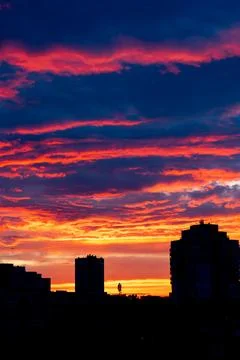 Orange-red colored cloudy sky after sunset, cloud formation, evening sky, sunset Stock Photos