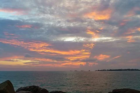 Orange-red sunset with clouds and the sea Stock Photos