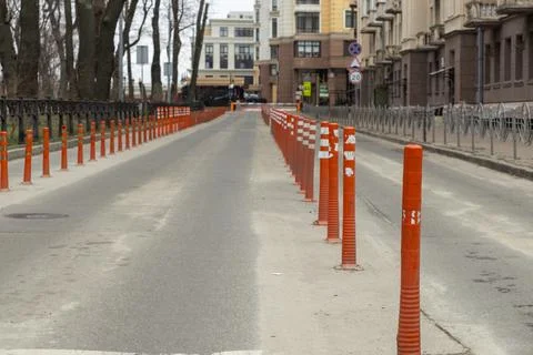 Orange reflective traffic delineators line a city street, effectively separ.. Stock Photos