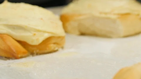 Orange roll being placed on tray with other rolls slow motion Video stock 93381196
