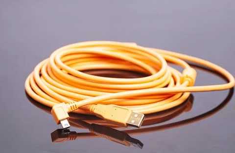 Orange rolled cable on black background Foto stock