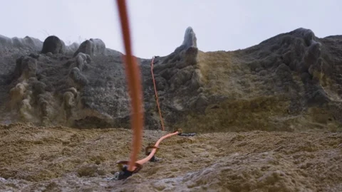An orange rope moves in the quickdraws on a climbing route, Margalef, Spain Stock Footage 289295022
