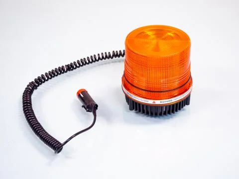 Orange rotating beacon on white reflective background. Foto stock