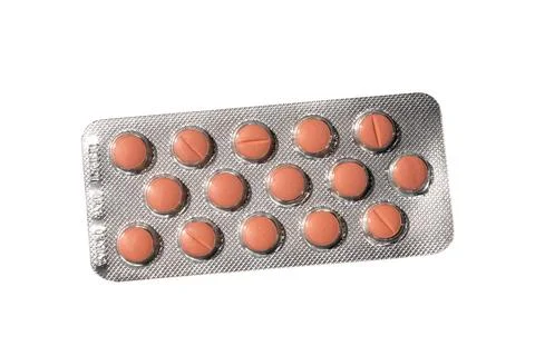 Orange Round Tablets in Blister Pack on White Background Stock Photos