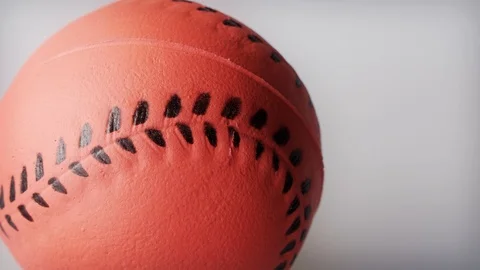 Orange rubber toy baseball close up background stock footage Stock Footage 102798503