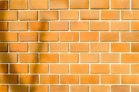 Orange ruled brick wall texture background Stock Photos