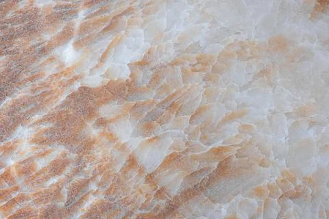 Orange rust-colored marble stone surface shows natural mineral patterns. Th.. Stock Photos