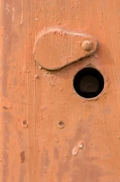Orange rusty doors texture. switchboard cover with keyhole. Stock Photos
