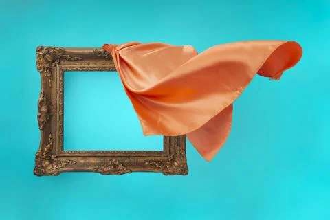 Orange satin fabric unveiling a empty baroque frame, on turquoise backgroun.. Stock Photos