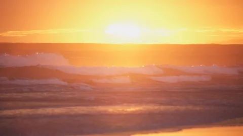 Orange scene as sun sets behind horizon line of Pacific Ocean Stock Footage 93722809
