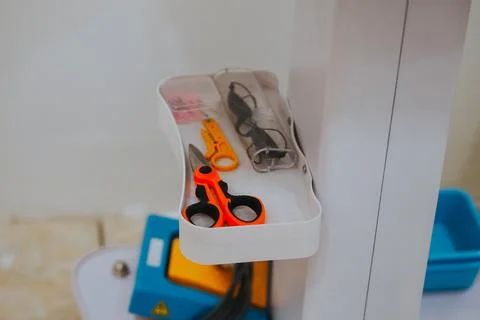 Orange scissors on a tray Stock Photos