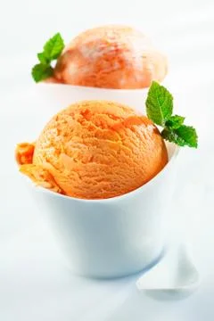 Orange scoops of icecream Stock Photos