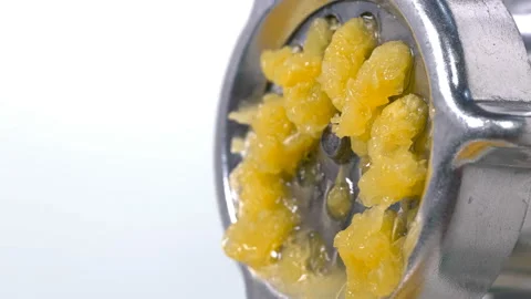 Orange is scrolled through a meat grinder and it comes out in small pieces Stock Footage 117398743