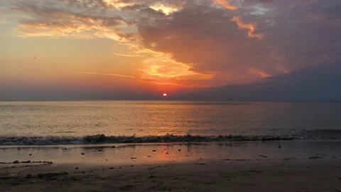 Orange sea sunset, beautiful clouds. Small waves reaching the beach. Timelapse. Stock Footage