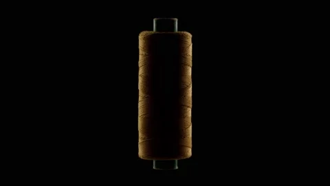 Orange sewing thread on a black background Stock Footage 147553472