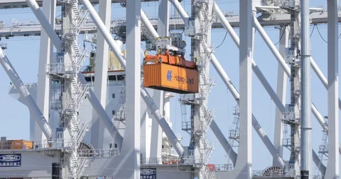 Orange Shipping Container Being Lifted Towards Ship Video stock 129216560