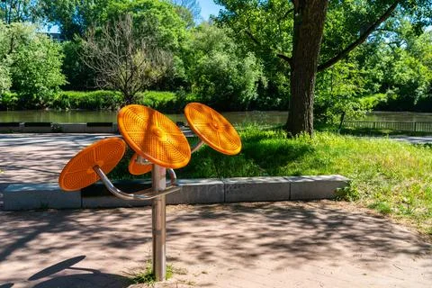 Orange shoulder girdle exercise machine located in the park. Stock Photos