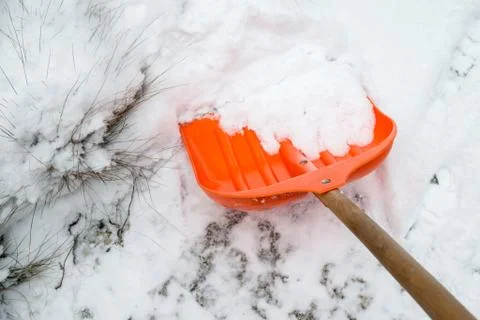 Orange shovel for snow removal Stock Photos