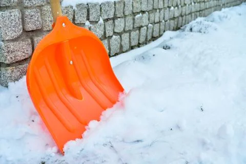 Orange shovel for snow removal Stock Photos