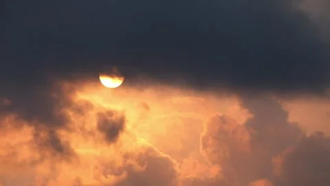 Orange sky in the afternoon as dramatic clouds cross the sun Stock Footage 286905141