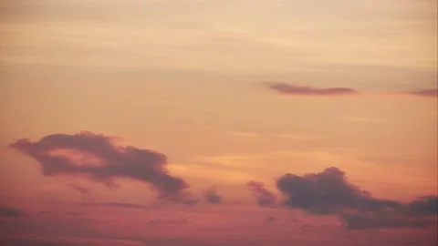 Orange sky with disappearing clouds at dusk. Video stock 198225231