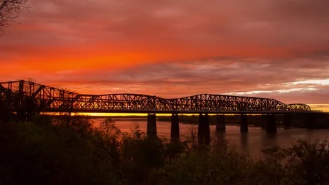 Orange sky during winter sunset across bridge 스톡 동영상 79543208
