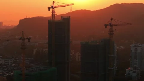 Orange sky over construction site during sunset, buildings under construction Stock Footage 332832056