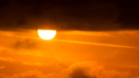 Orange sky, white sun, dark clouds - sunrise, sky background - Real Time - birds Stock Footage 152565773