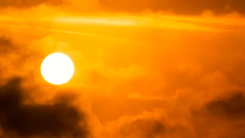 Orange sky, white sun, dark clouds - sunrise, sky background - Time Lapse Stock Footage 152566050