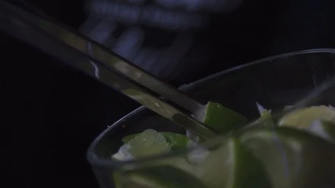 Orange slice being dropped into glass Stock Footage 90123636