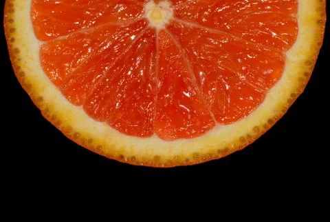 Orange slice on black Stock Photos