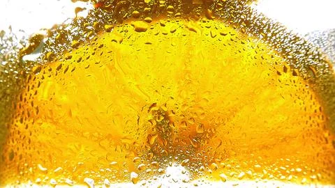 Orange slice close-up seen through glass with water droplets, macro photogr.. Stock Photos