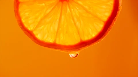 Orange slice with drop of orange juice close-up. Fresh and juicy Grapefruit Stock Footage 162650981
