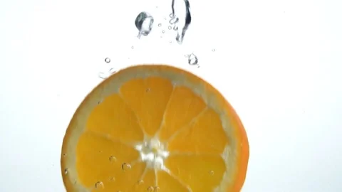 An orange slice falling down into the water Stock Footage 101608239