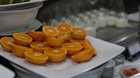 Orange slice falling on a white plate in slow motion. Ripe organic citrus fruits Stock Footage 310186172