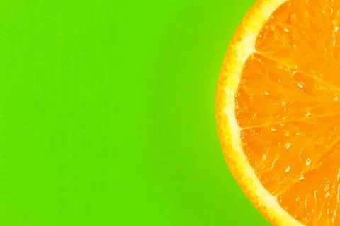 Orange slice on a green background macro. place for the label Stock-Fotos