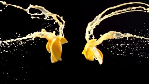 Orange slice with juice droplets collide on black background super slow motion Stock Footage 116959899