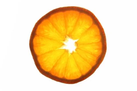 Orange slice lightened from behind Stock Photos