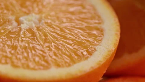 Orange slice macro with glossy citrus pulp and juicy fresh texture background Stock Footage 330466902