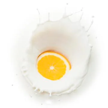 Orange slice in milk splash Stock Photos